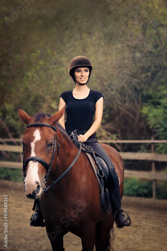 Happy Horsewoman Ridding in a Manege