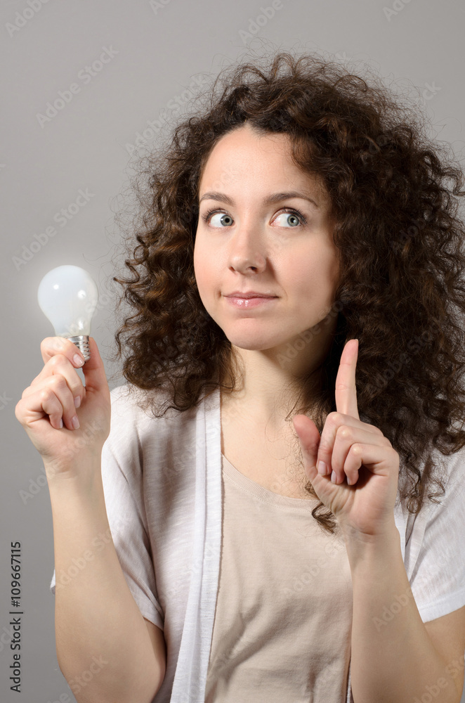 Beautiful business woman with idea light bulb Beautiful business woman with idea light bulb