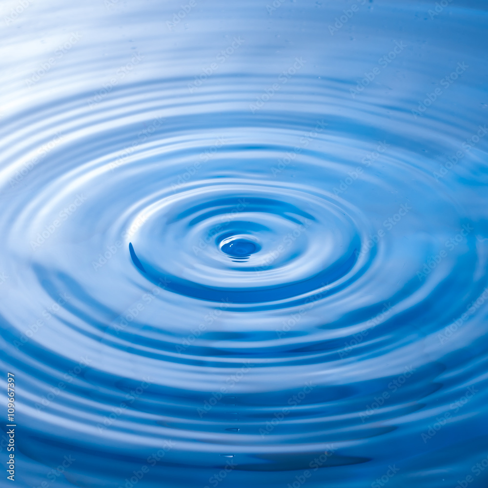 a water drop impact with water surface, causing rings on the sur a water drop impact with water surface, causing rings on the sur