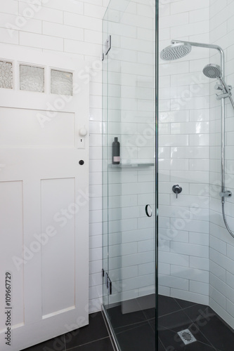 Modern white shower in bathroom renovation with brick pattern ti