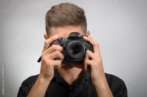 man taking picture with photo camera DSLR