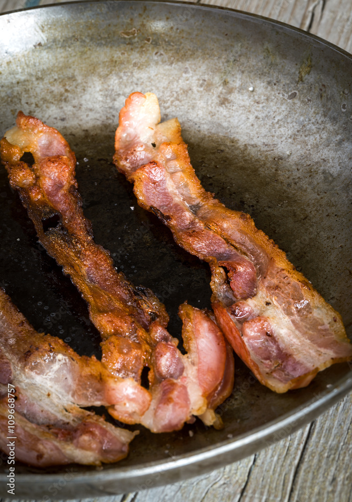 Close-up of bacon slices on frying pan