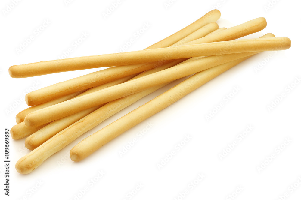 bunch of bread sticks on a white background