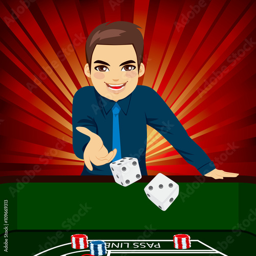 Handsome young man playing craps throwing dice on casino