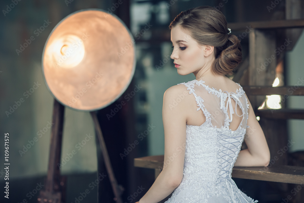 Naklejka premium The young beautiful bride with professional hairstyle and makeup 