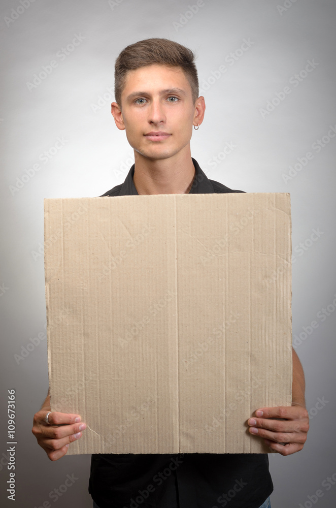 man holding a blank board