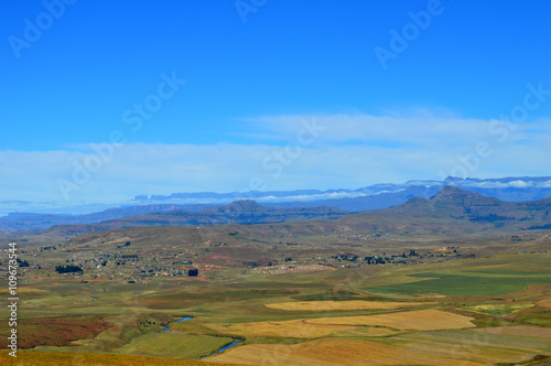 Drakensberg mountains with grass and trails and blue sky