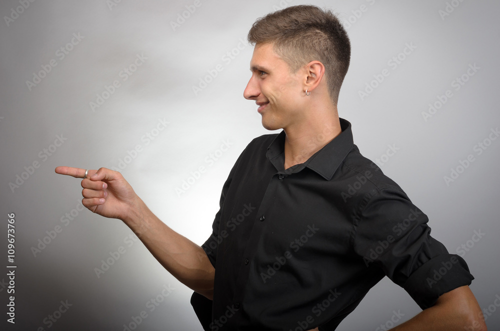 Young handsome businessman pointing to something using a finger. Left Young handsome businessman pointing to something using a finger. Left