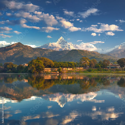 Panoramic view from the lakeside at the foothills of the magnificent mountain range. photo