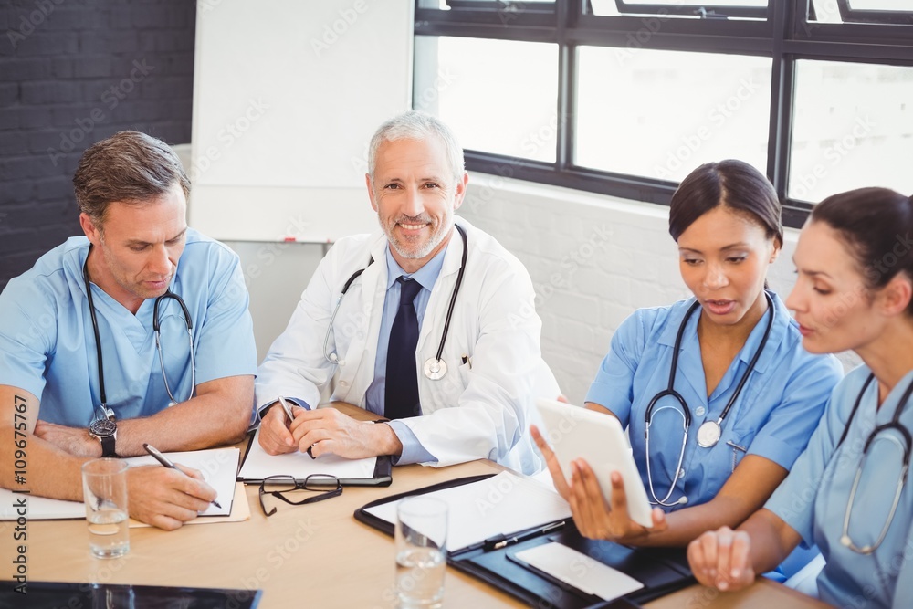 Portrait of male doctor smiling in conference room Portrait of male doctor smiling in conference room
