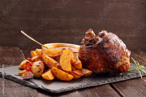 Knuckle of turkey with baked potato and dip photo