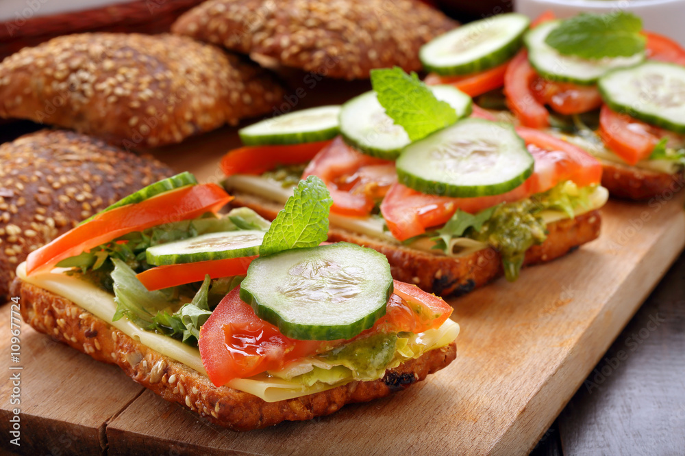 Vegetarian sandwich with pesto on wooden background Vegetarian sandwich with pesto on wooden background