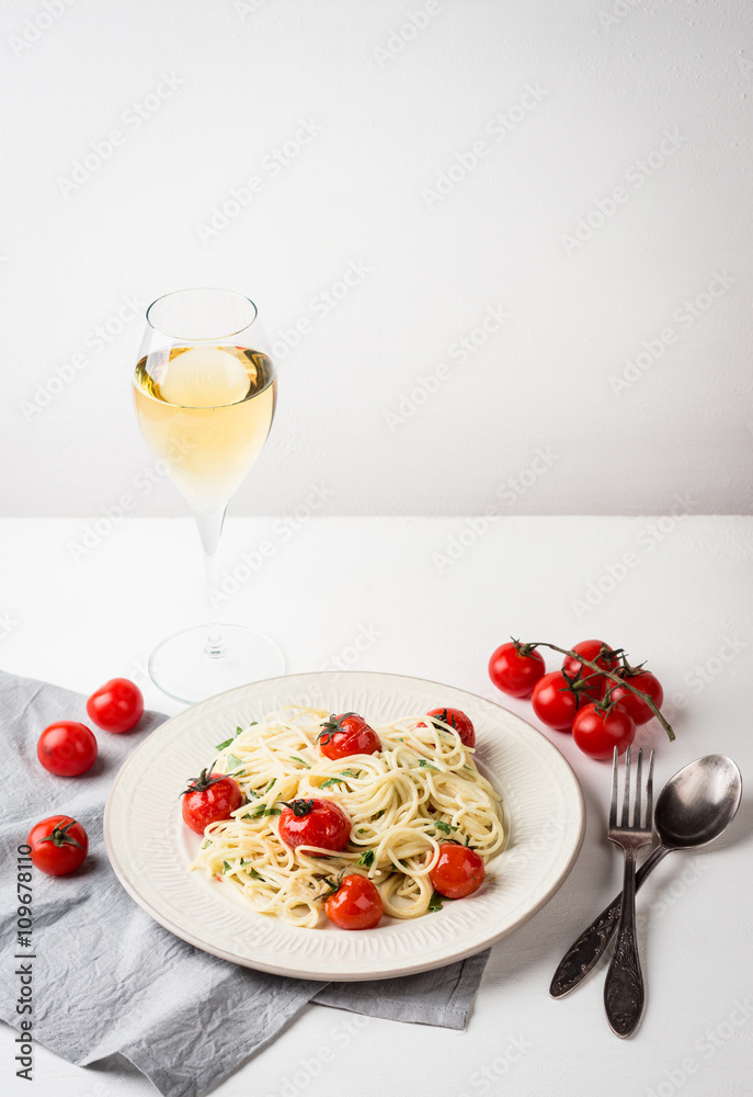 Pasta with cherry tomatoes on the wooden background