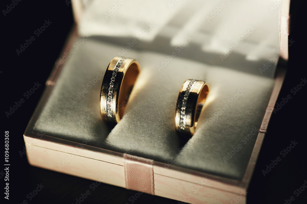 Gold wedding rings with crystals in the box Gold wedding rings with crystals in the box