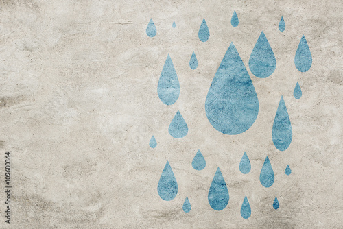 Urban wall with painted blue raindrops falling down