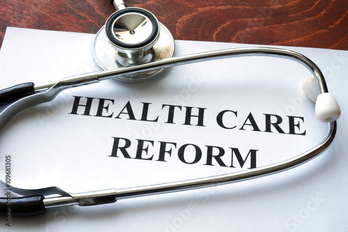 Photos Words healthcare reform written on a paper.