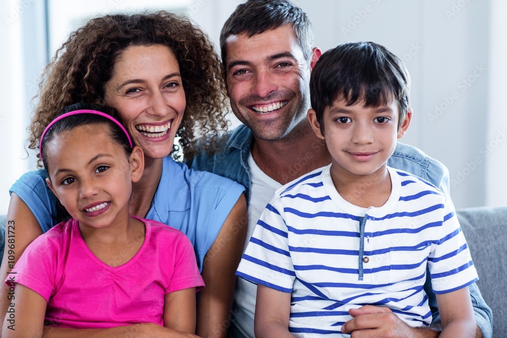 Portrait of happy family sitting together on sofa