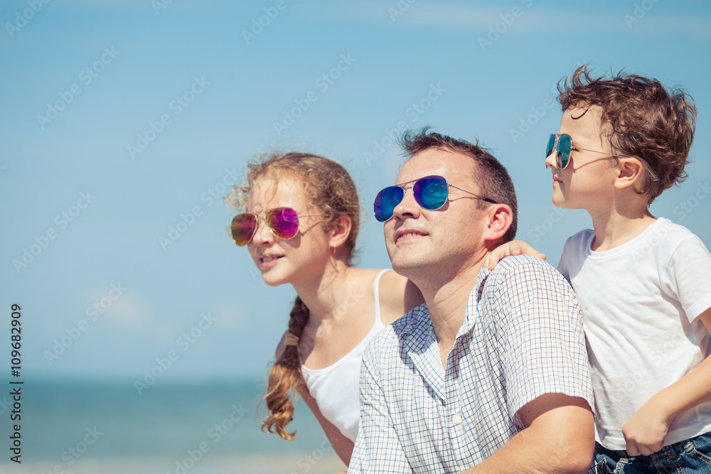 Father and children playing on the beach at the day time. Father and children playing on the beach at the day time.