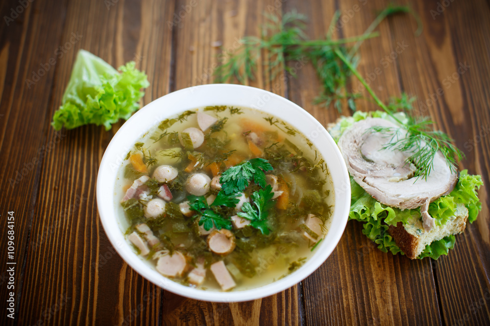 vegetable soup with sausages in a plate