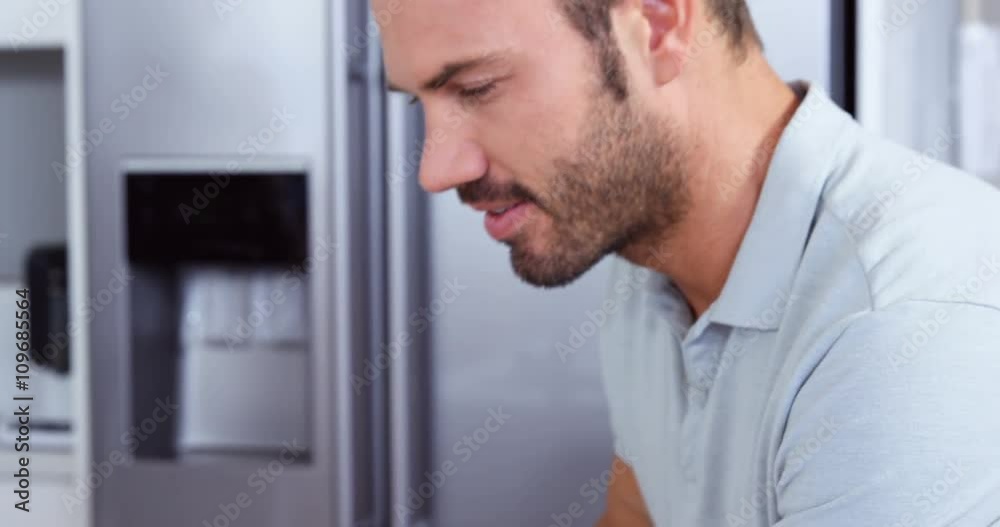 Handsome man using tablet while drinking coffee Handsome man using tablet while drinking coffee