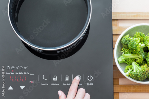 фотографія Woman select function on Induction stove