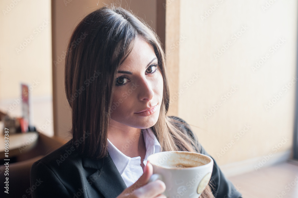 girl with unusual eyes in suit holding Cup of coffee girl with unusual eyes in suit holding Cup of coffee