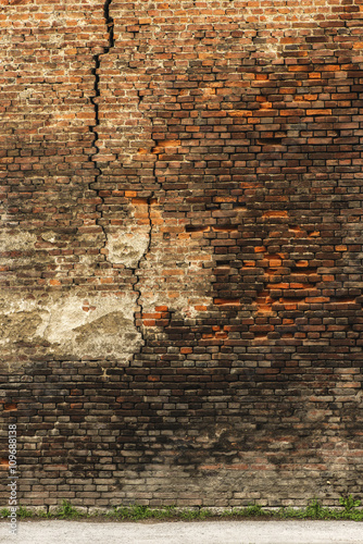 Grunge background, red brick wall texture bright plaster wall and blocks road sidewalk abandoned exterior urban background.