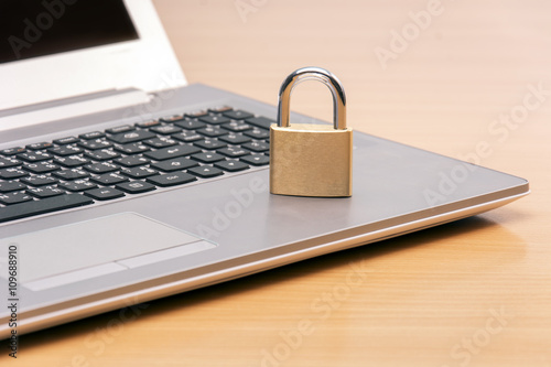 padlock on laptop - computer security concept