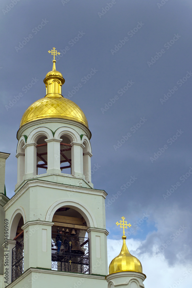 The bell tower of the church a background of storm clouds