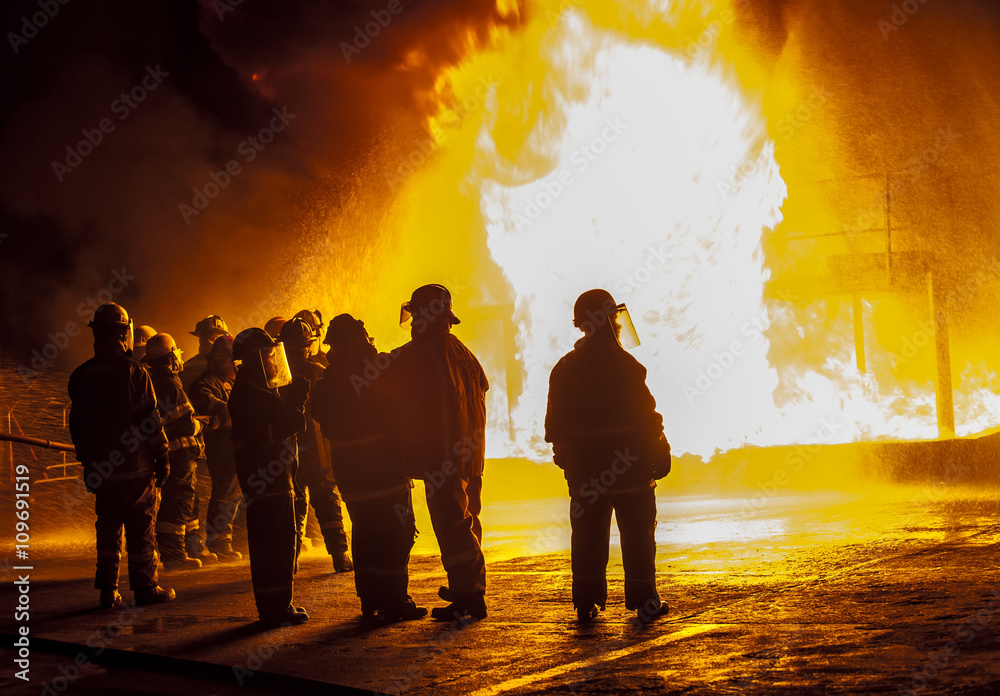 Fototapeta premium Firefighters observing structural fire