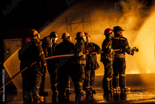 Group of firefighters fighting a burning fire