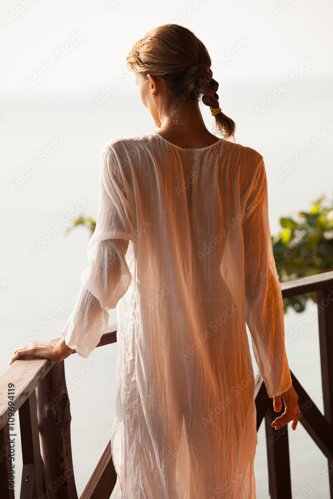 femme sur un balcon dans une robe transparente Stock Photo | Adobe Stock