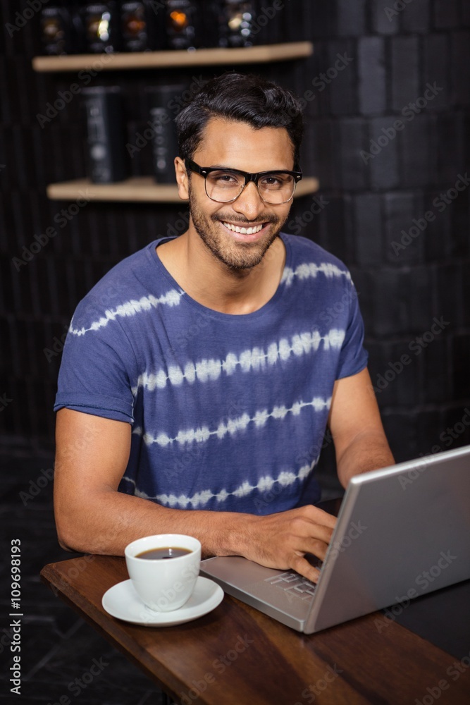 Man using a laptop in a coffee shop