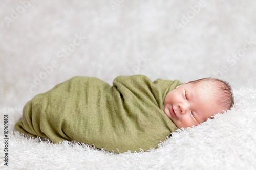 Beautiful newborn wrapped in a blanket photo