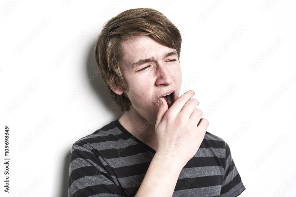 standing young tired man yawning and stretching standing young tired man yawning and stretching
