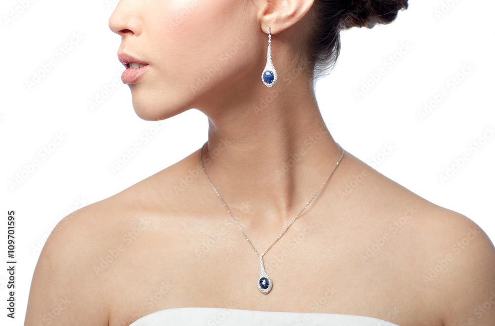 close up of woman with earring and pendant