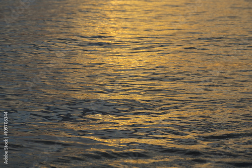 Calm ocean water on summer sunset
