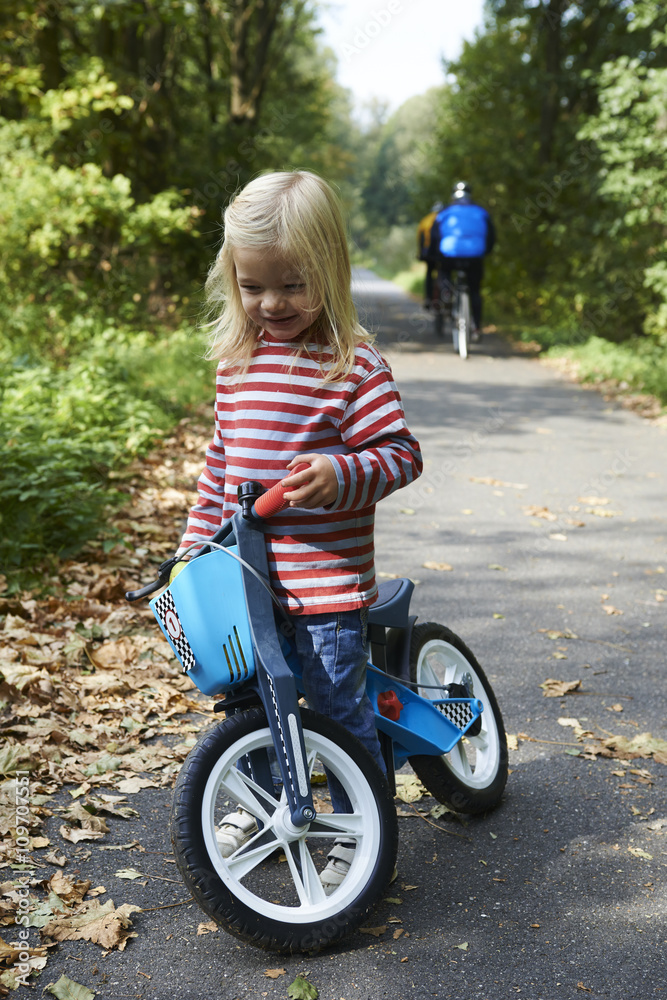 cute little girl riding runbike in summer
cute little girl riding runbike in summer
