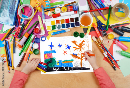 car with vegetables crop and birds, child drawing , top view hands with pencil painting picture on paper, artwork workplace