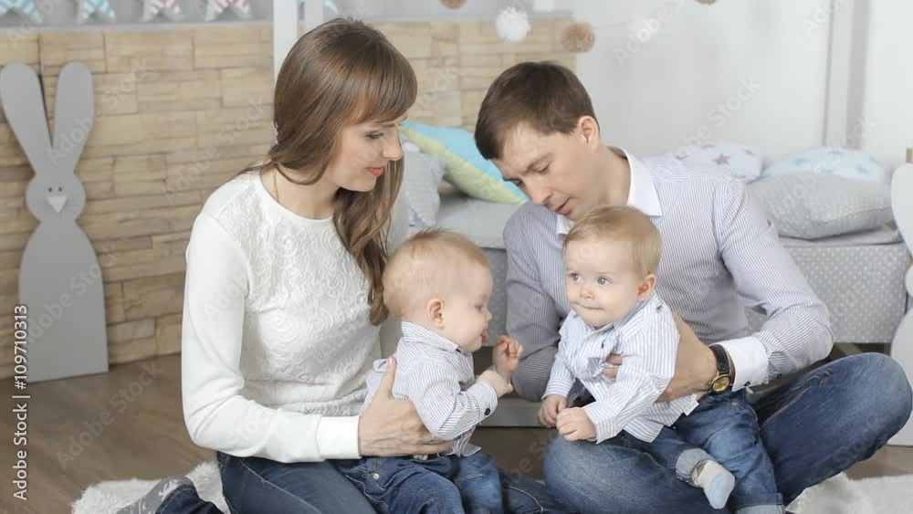 Parents with baby boy twins. people, family, happiness concept and idea. Parents with baby boy twins. people, family, happiness concept and idea.