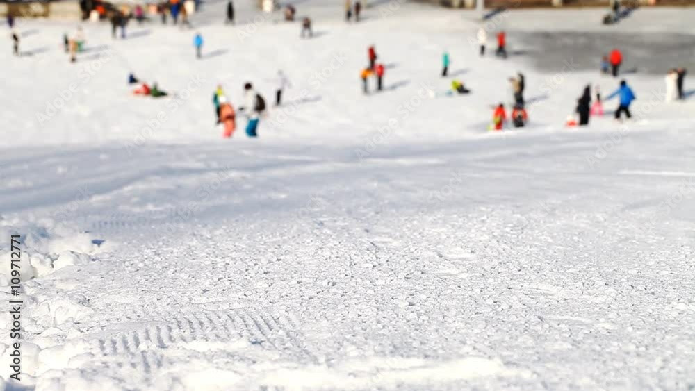 Skiers and snowboarders going down the slope Skiers and snowboarders going down the slope