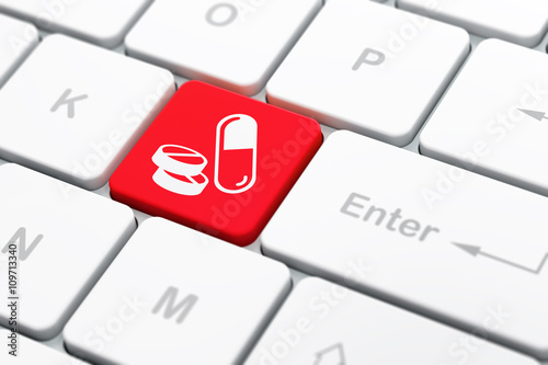 Healthcare concept: Pills on computer keyboard background