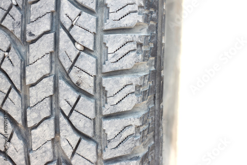 Tire skin with dust on white background, close-up.