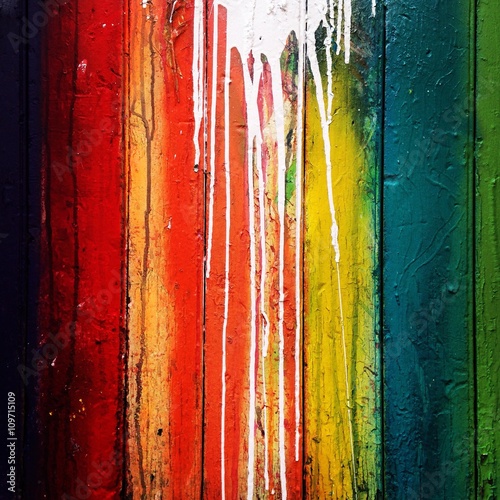 White drips on colorful wall