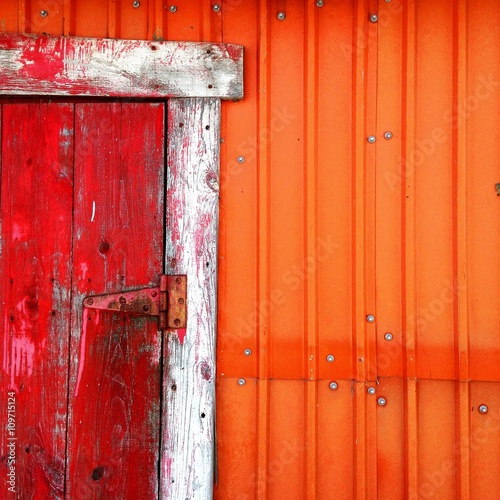 Old shack with red door and orange wall
