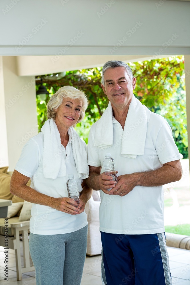 Fototapeta premium Happy senior couple holding water bottles