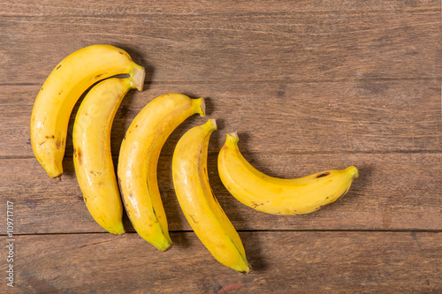 Fresh bananas on wooden background