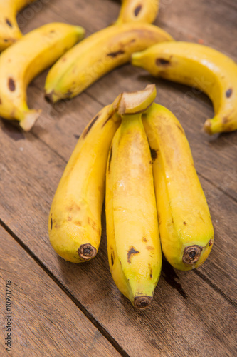 Fresh bananas on wooden background