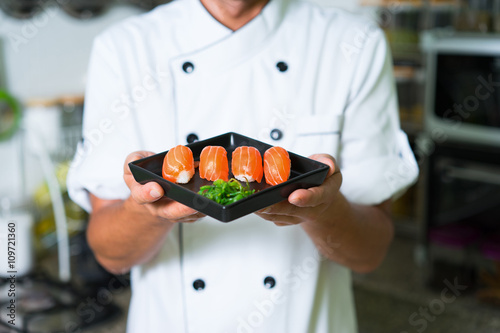 Sticker Close up Sushi in chefs hands. Focus on sushi