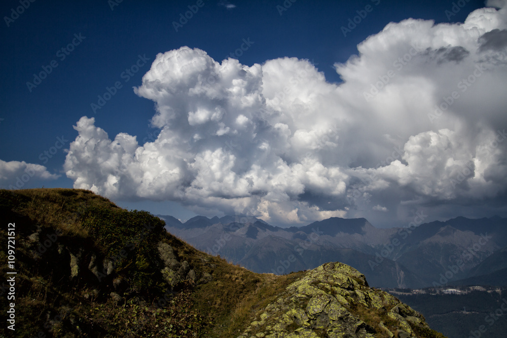 Mountain landscape with cumulus clouds